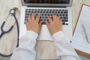 top view doctor working with laptop 2