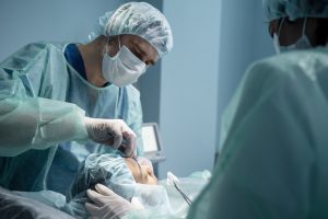 doctors performing rhinoplasty operating room