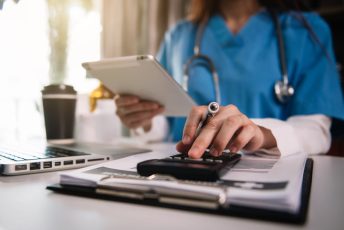 Doctor,Physician,With,Stethoscope,Calculate,Medical,Fee,Costs,&,Revenue.