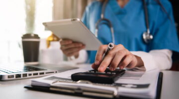 Doctor,Physician,With,Stethoscope,Calculate,Medical,Fee,Costs,&,Revenue.