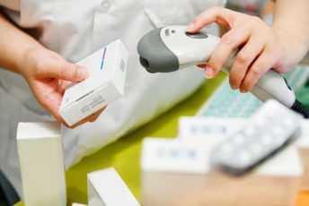 Pharmacist,Scanning,Barcode,Of,Medicine,Drug,In,A,Pharmacy,Drugstore