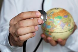 Doctor,With,Stethoscope,And,Globe,In,His,Hand.,Medical,Network