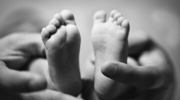 Parent,Holding,Newborn,Baby,Feet.,Family,Concept.,Black,And,White