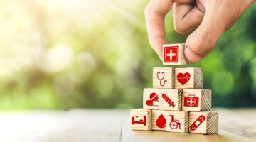 Hand,Arranged,Wooden,Blocks,With,Icons,Of,Medical,Health.,Health